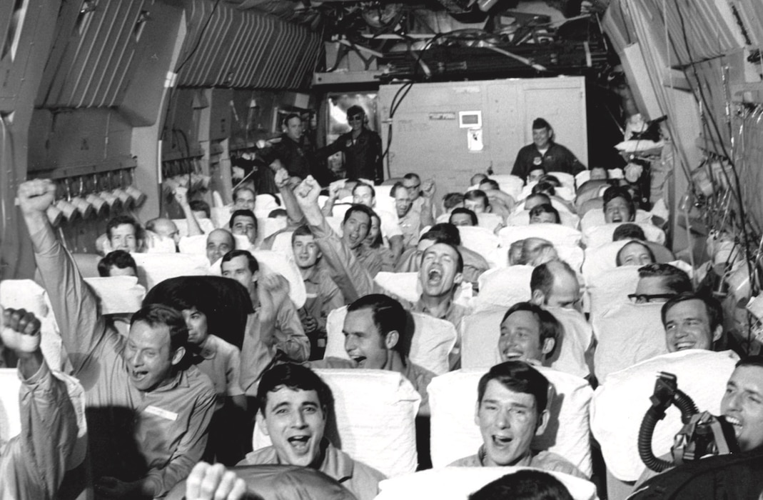Image of Airmen riding in an aircraft.