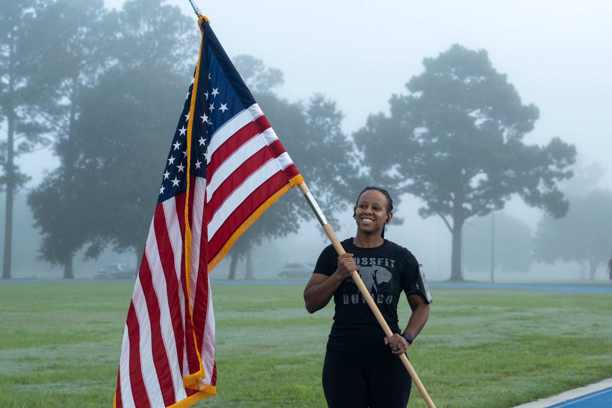 Airmen holds U.S. flag during remembrance run.