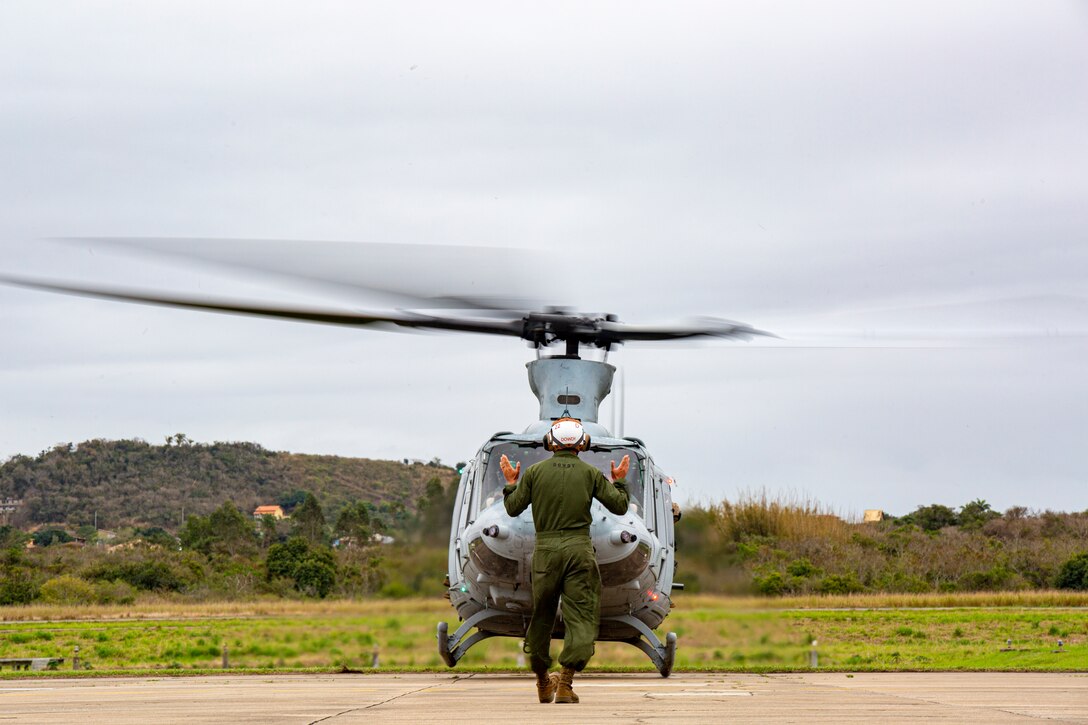 Sgt. Ty Dowdy, a plane captain, with Marine Light Attack Helicopter Squadron - 773, 4th Marine Aircraft Wing, Marine Forces Reserve in support of Special Purpose Marine Air-Ground Task Force UNITAS LXIII, conducts a hover test for a UH-1Y Venom at São Pedro da Aldeia, Brazil, during exercise UNITAS LXIII, Sept. 5, 2022. UNITAS is the world's longest-running annual multinational maritime exercise that focuses on enhancing interoperability among multiple nations and joint forces during littoral and amphibious operations in order to build on existing regional partnerships and create new enduring relationships that promote peace, stability, and prosperity in the U.S. Southern Command’s area of responsibility. Dowdy is a native of Cedartown, GA. (U.S. Marine Corps photo by 1st Lt. Mark L. Andries)