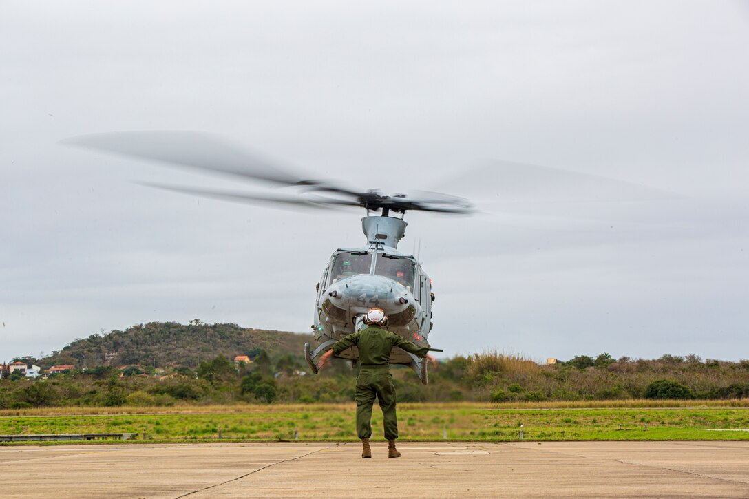 U.S. Marine Corps Sgt. Ty Dowdy, a plane captain, with Marine Light Attack Helicopter Squadron - 773, 4th Marine Aircraft Wing, Marine Forces Reserve in support of Special Purpose Marine Air-Ground Task Force UNITAS LXIII, conducts a hover test for a UH-1Y Venom at São Pedro da Aldeia, Brazil, during exercise UNITAS LXIII, Sept. 5, 2022. UNITAS is the world's longest-running annual multinational maritime exercise that focuses on enhancing interoperability among multiple nations and joint forces during littoral and amphibious operations in order to build on existing regional partnerships and create new enduring relationships that promote peace, stability, and prosperity in the U.S. Southern Command’s area of responsibility. Dowdy is a native of Cedartown, GA. (U.S. Marine Corps photo by 1st Lt. Mark L. Andries)