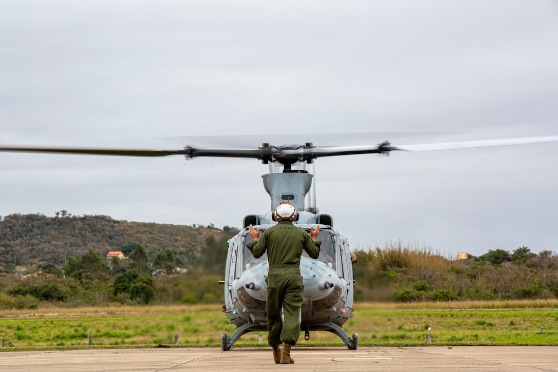 Sgt. Ty Dowdy, a plane captain, with Marine Light Attack Helicopter Squadron - 773, 4th Marine Aircraft Wing, Marine Forces Reserve in support of Special Purpose Marine Air-Ground Task Force UNITAS LXIII, conducts a hover test for a UH-1Y Venom at São Pedro da Aldeia, Brazil, during exercise UNITAS LXIII, Sept. 5, 2022. UNITAS is the world's longest-running annual multinational maritime exercise that focuses on enhancing interoperability among multiple nations and joint forces during littoral and amphibious operations in order to build on existing regional partnerships and create new enduring relationships that promote peace, stability, and prosperity in the U.S. Southern Command’s area of responsibility. Dowdy is a native of Cedartown, GA. (U.S. Marine Corps photo by 1st Lt. Mark L. Andries)