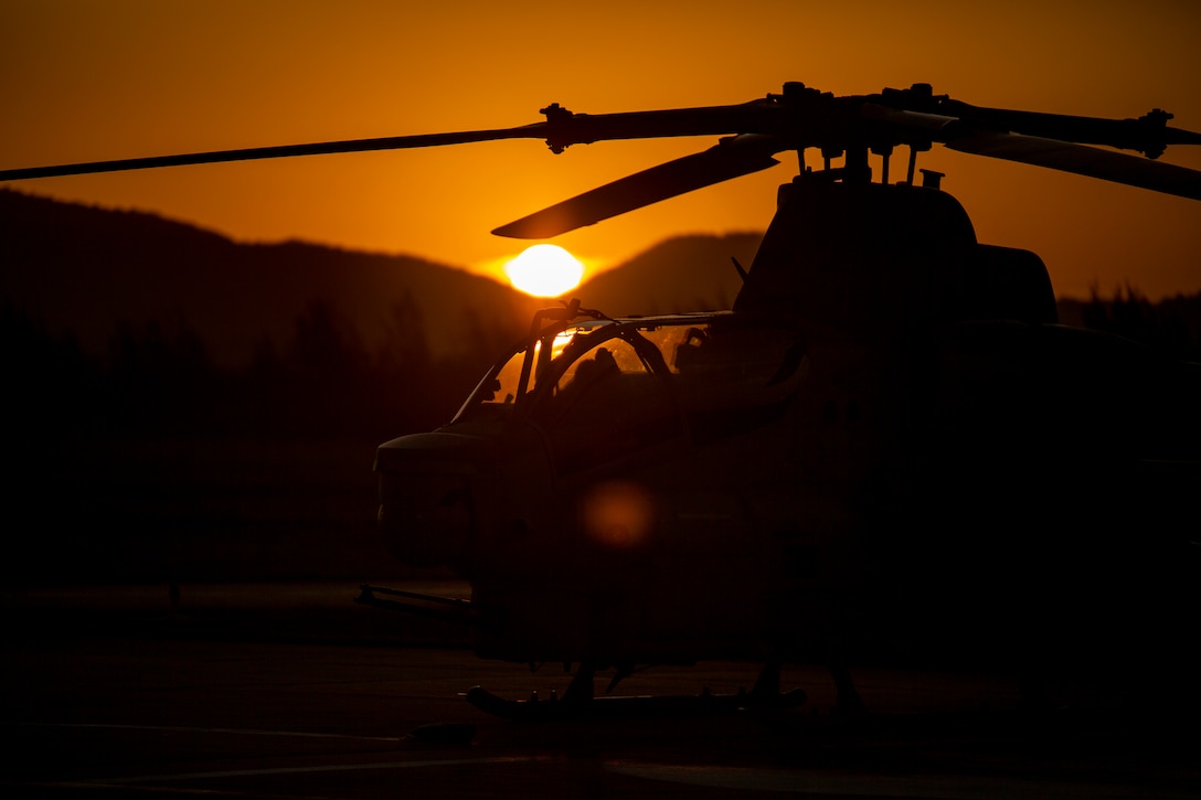An AH-1Z Viper with Marine Light Attack Helicopter Squadron - 773, 4th Marine Aircraft Wing, Marine Forces Reserve in support of Special Purpose Marine Air-Ground Task Force UNITAS LXIII, sits on the flight lines at sunset at São Pedro da Aldeia, Brazil, during exercise UNITAS LXIII, Sept. 7, 2022. UNITAS is the world's longest-running annual multinational maritime exercise that focuses on enhancing interoperability among multiple nations and joint forces during littoral and amphibious operations in order to build on existing regional partnerships and create new enduring relationships that promote peace, stability, and prosperity in the U.S. Southern Command’s area of responsibility. (U.S. Marine Corps photo by 1st Lt. Mark L. Andries)