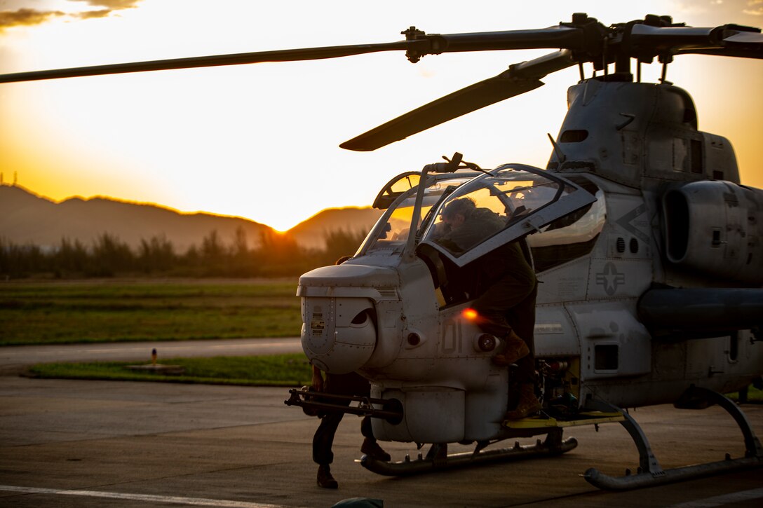 U.S. Marines with Marine Light Attack Helicopter Squadron - 773, 4th Marine Aircraft Wing, Marine Forces Reserve in support of Special Purpose Marine Air-Ground Task Force UNITAS LXIII, conduct routine maintenance on an AH-1Z Viper at São Pedro da Aldeia, Brazil, during exercise UNITAS LXIII, Sept. 7, 2022. UNITAS is the world's longest-running annual multinational maritime exercise that focuses on enhancing interoperability among multiple nations and joint forces during littoral and amphibious operations in order to build on existing regional partnerships and create new enduring relationships that promote peace, stability, and prosperity in the U.S. Southern Command’s area of responsibility. (U.S. Marine Corps photo by 1st Lt. Mark L. Andries)