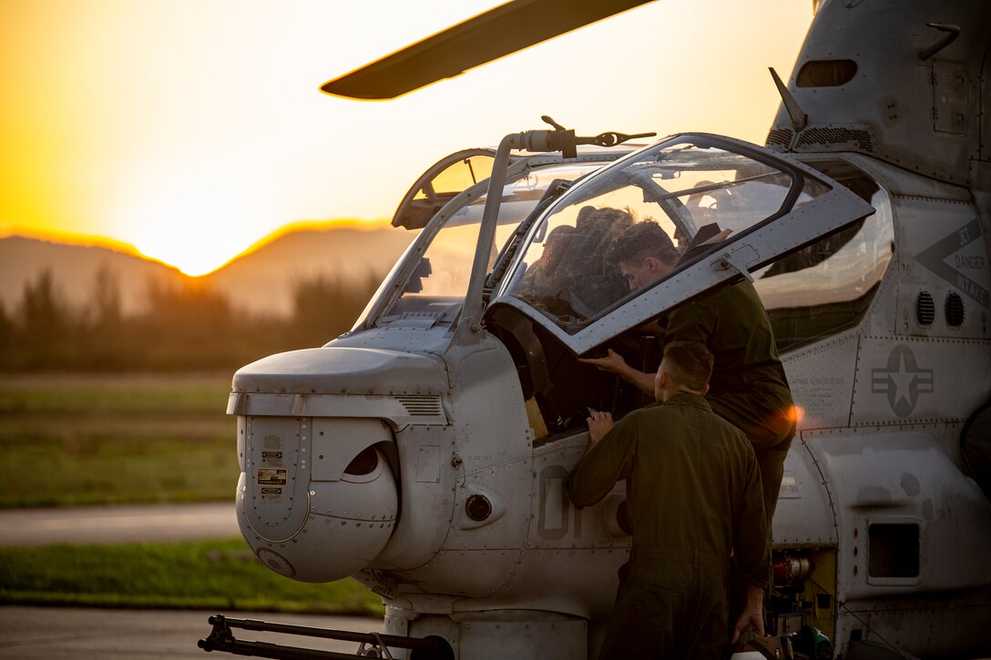 U.S. Marines with Marine Light Attack Helicopter Squadron - 773, 4th Marine Aircraft Wing, Marine Forces Reserve in support of Special Purpose Marine Air-Ground Task Force UNITAS LXIII, conduct routine maintenance on an AH-1Z Viper at São Pedro da Aldeia, Brazil, during exercise UNITAS LXIII, Sept. 7, 2022. UNITAS is the world's longest-running annual multinational maritime exercise that focuses on enhancing interoperability among multiple nations and joint forces during littoral and amphibious operations in order to build on existing regional partnerships and create new enduring relationships that promote peace, stability, and prosperity in the U.S. Southern Command’s area of responsibility. (U.S. Marine Corps photo by 1st Lt. Mark L. Andries)