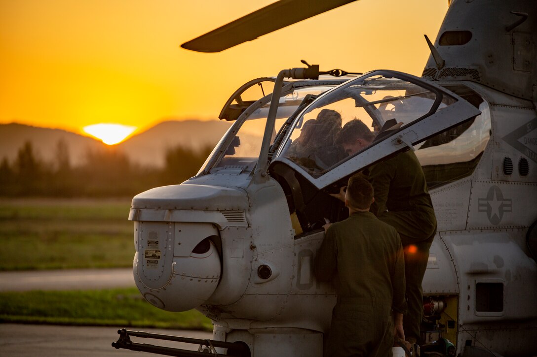 U.S. Marines with Marine Light Attack Helicopter Squadron - 773, 4th Marine Aircraft Wing, Marine Forces Reserve in support of Special Purpose Marine Air-Ground Task Force UNITAS LXIII, conduct routine maintenance on an AH-1Z Viper at São Pedro da Aldeia, Brazil, during exercise UNITAS LXIII, Sept. 7, 2022. UNITAS is the world's longest-running annual multinational maritime exercise that focuses on enhancing interoperability among multiple nations and joint forces during littoral and amphibious operations in order to build on existing regional partnerships and create new enduring relationships that promote peace, stability, and prosperity in the U.S. Southern Command’s area of responsibility. (U.S. Marine Corps photo by 1st Lt. Mark L. Andries)