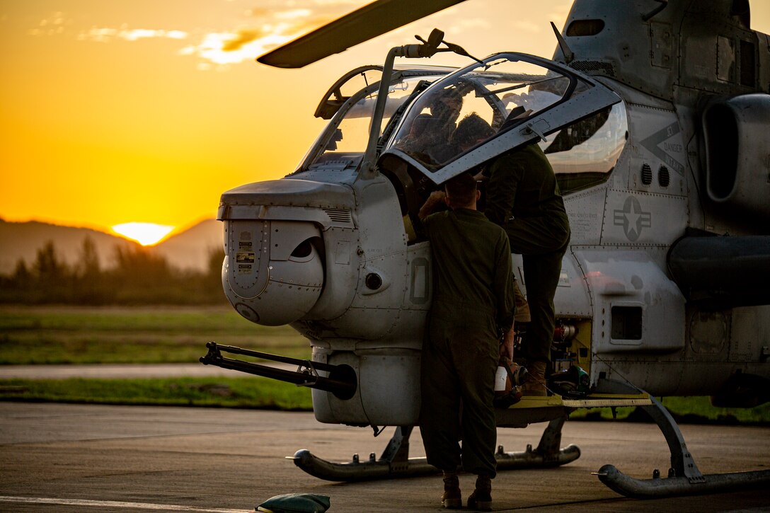 U.S. Marines with Marine Light Attack Helicopter Squadron - 773, 4th Marine Aircraft Wing, Marine Forces Reserve in support of Special Purpose Marine Air-Ground Task Force UNITAS LXIII, conduct routine maintenance on an AH-1Z Viper at São Pedro da Aldeia, Brazil, during exercise UNITAS LXIII, Sept. 7, 2022. UNITAS is the world's longest-running annual multinational maritime exercise that focuses on enhancing interoperability among multiple nations and joint forces during littoral and amphibious operations in order to build on existing regional partnerships and create new enduring relationships that promote peace, stability, and prosperity in the U.S. Southern Command’s area of responsibility. (U.S. Marine Corps photo by 1st Lt. Mark L. Andries)