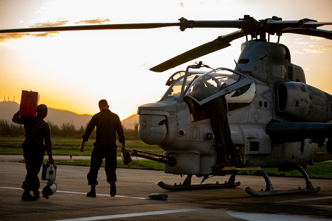 U.S. Marines with Marine Light Attack Helicopter Squadron - 773, 4th Marine Aircraft Wing, Marine Forces Reserve in support of Special Purpose Marine Air-Ground Task Force UNITAS LXIII, conduct routine maintenance on an AH-1Z Viper at São Pedro da Aldeia, Brazil, during exercise UNITAS LXIII, Sept. 7, 2022. UNITAS is the world's longest-running annual multinational maritime exercise that focuses on enhancing interoperability among multiple nations and joint forces during littoral and amphibious operations in order to build on existing regional partnerships and create new enduring relationships that promote peace, stability, and prosperity in the U.S. Southern Command’s area of responsibility. (U.S. Marine Corps photo by 1st Lt. Mark L. Andries)