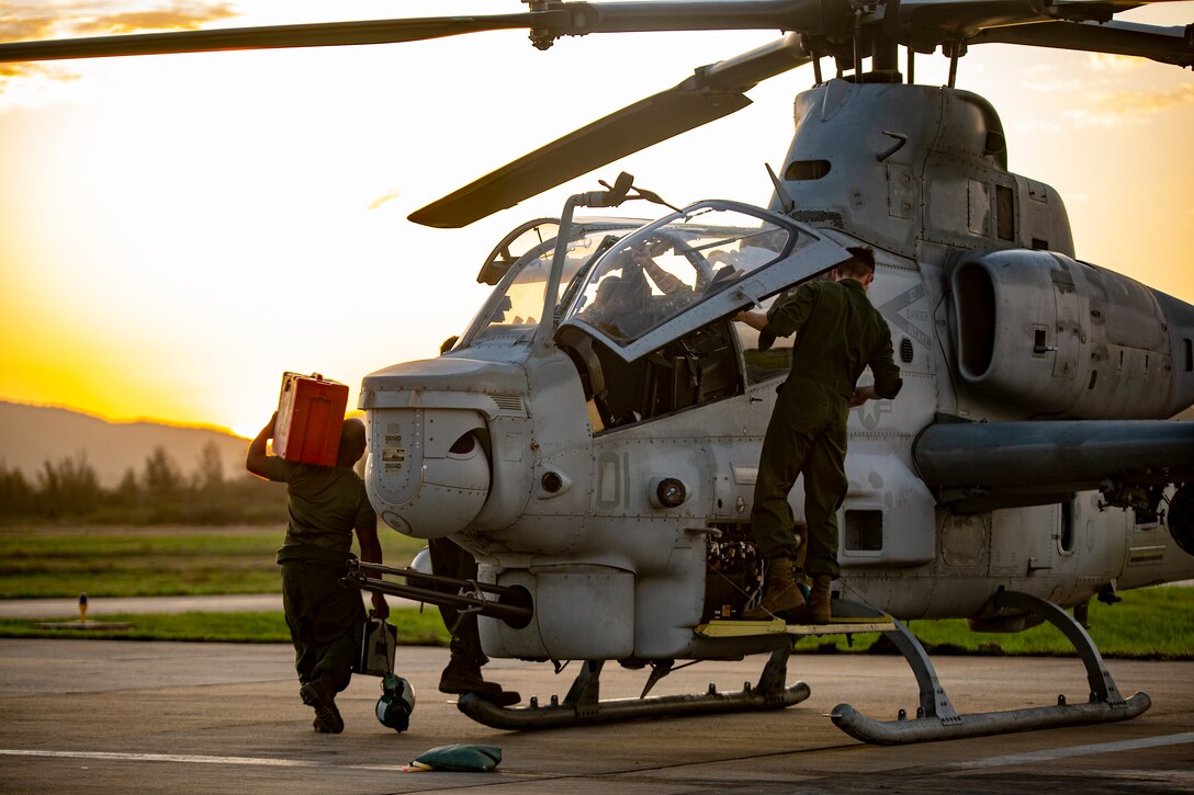 U.S. Marines with Marine Light Attack Helicopter Squadron - 773, 4th Marine Aircraft Wing, Marine Forces Reserve in support of Special Purpose Marine Air-Ground Task Force UNITAS LXIII, conduct routine maintenance on an AH-1Z Viper at São Pedro da Aldeia, Brazil, during exercise UNITAS LXIII, Sept. 7, 2022. UNITAS is the world's longest-running annual multinational maritime exercise that focuses on enhancing interoperability among multiple nations and joint forces during littoral and amphibious operations in order to build on existing regional partnerships and create new enduring relationships that promote peace, stability, and prosperity in the U.S. Southern Command’s area of responsibility. (U.S. Marine Corps photo by 1st Lt. Mark L. Andries)