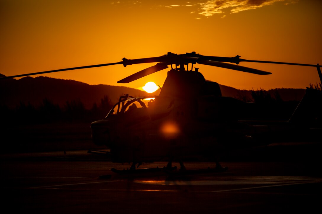 An AH-1Z Viper with Marine Light Attack Helicopter Squadron - 773, 4th Marine Aircraft Wing, Marine Forces Reserve in support of Special Purpose Marine Air-Ground Task Force UNITAS LXIII, sits on the flight lines at sunset at São Pedro da Aldeia, Brazil, during exercise UNITAS LXIII, Sept. 7, 2022. UNITAS is the world's longest-running annual multinational maritime exercise that focuses on enhancing interoperability among multiple nations and joint forces during littoral and amphibious operations in order to build on existing regional partnerships and create new enduring relationships that promote peace, stability, and prosperity in the U.S. Southern Command’s area of responsibility. (U.S. Marine Corps photo by 1st Lt. Mark L. Andries)