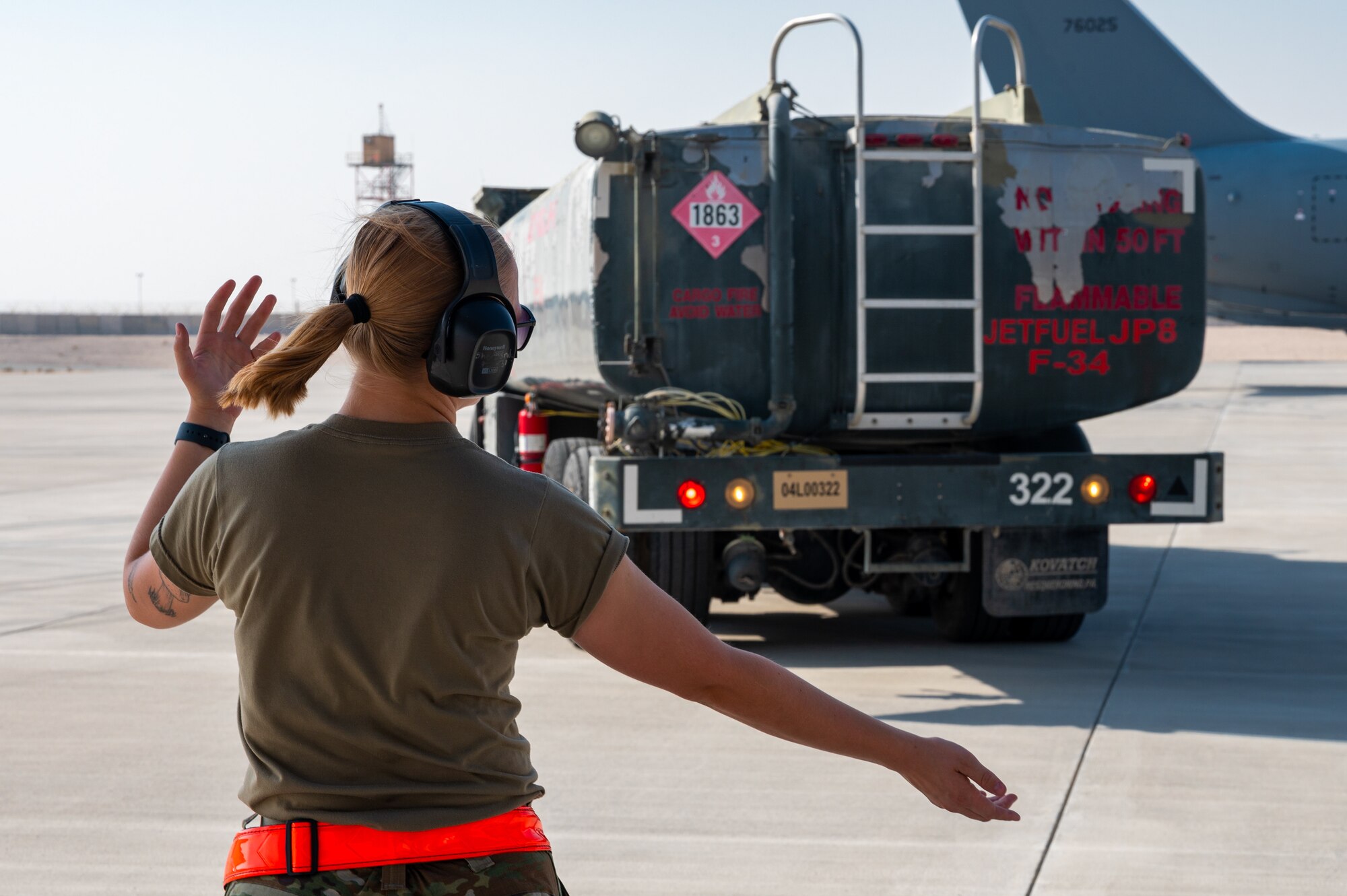 U.S. Air Force Senior Airman Abigail Sherbondy, 931st Maintenance Squadron crew chief, guides a fuel truck Aug. 30, 2022, at Al Udeid Air Base, Qatar.