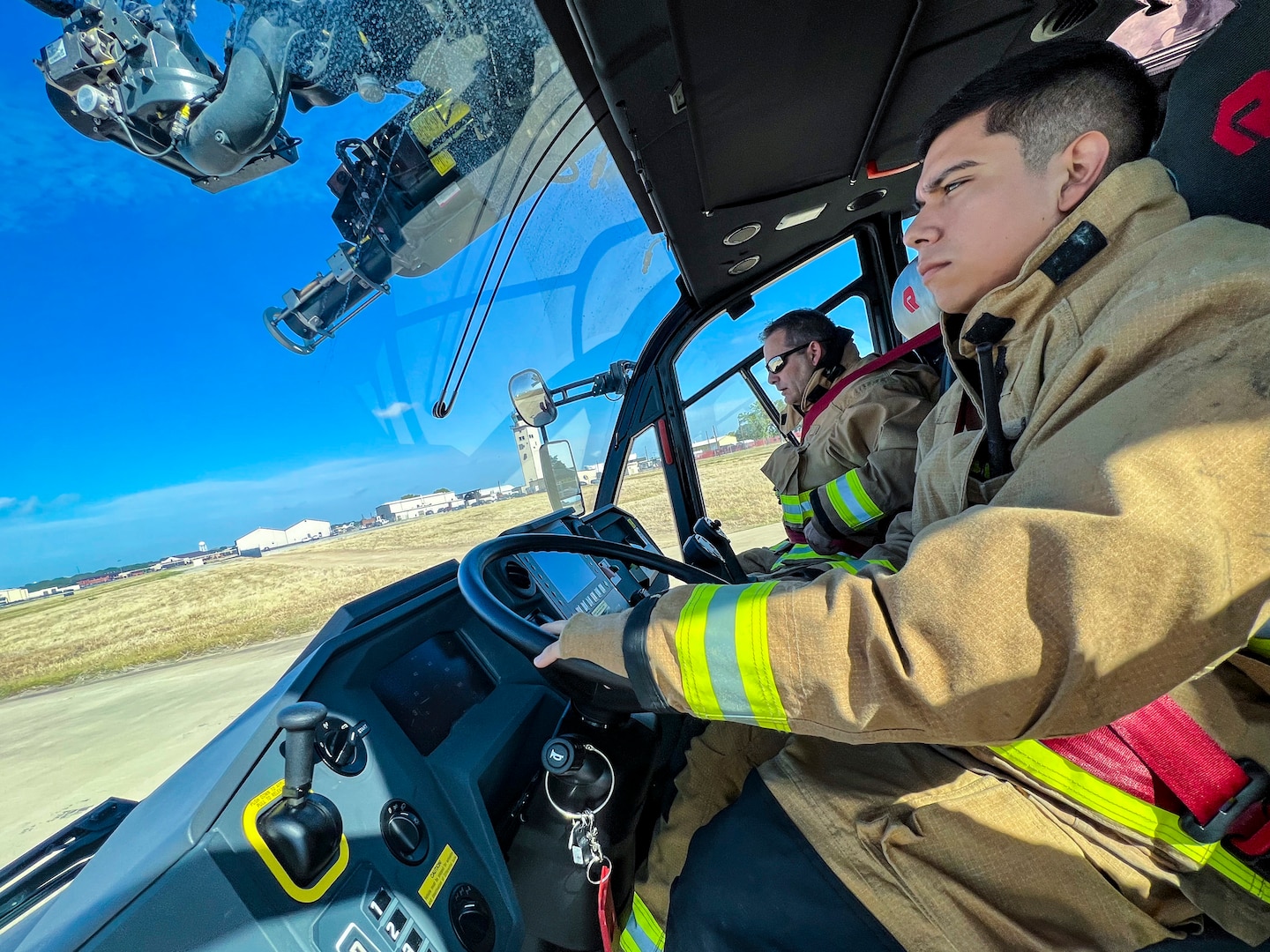 Firefighters Abel Saldivar (right) and Anthony Klima (left) from the 902nd Civil Engineer Squadron respond to an emergency response egress exercise for an F-16 Fighting Falcon at Joint Base San Antonio-Lackland Aug. 19, 2022.