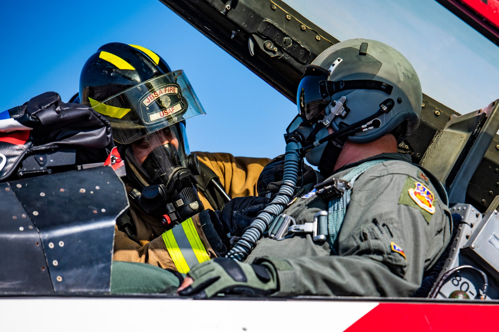 Michael Hillard, 902nd Civil Engineer Squadron firefighter, prepares Maj. Benjamin Wong, 149th Fighter Wing training officer, for extraction during an emergency response egress exercise for an F-16 Fighting Falcon at Joint Base San Antonio-Lackland, Texas, Aug. 19, 2022.