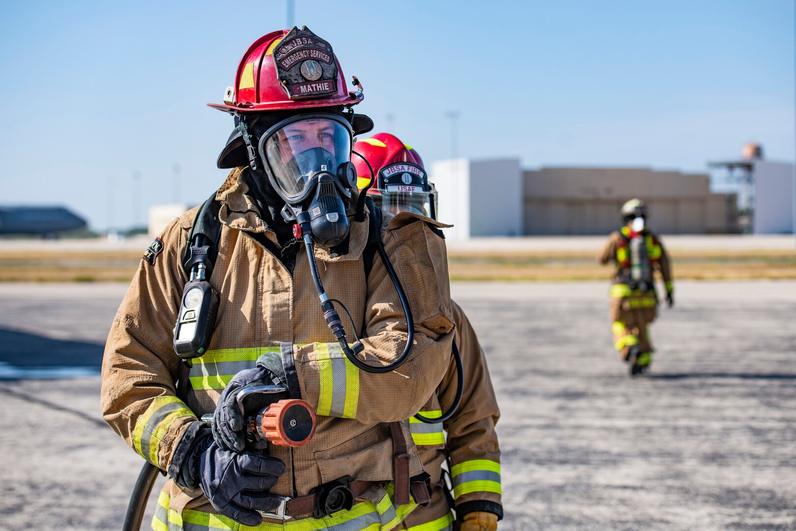 Jacob Mathie, 902nd Civil Engineer Squadron lead firefighter, stands ready during an emergency response egress exercise for an F-16 Fighting Falcon at Joint Base San Antonio-Lackland, Texas, Aug. 19, 2022.