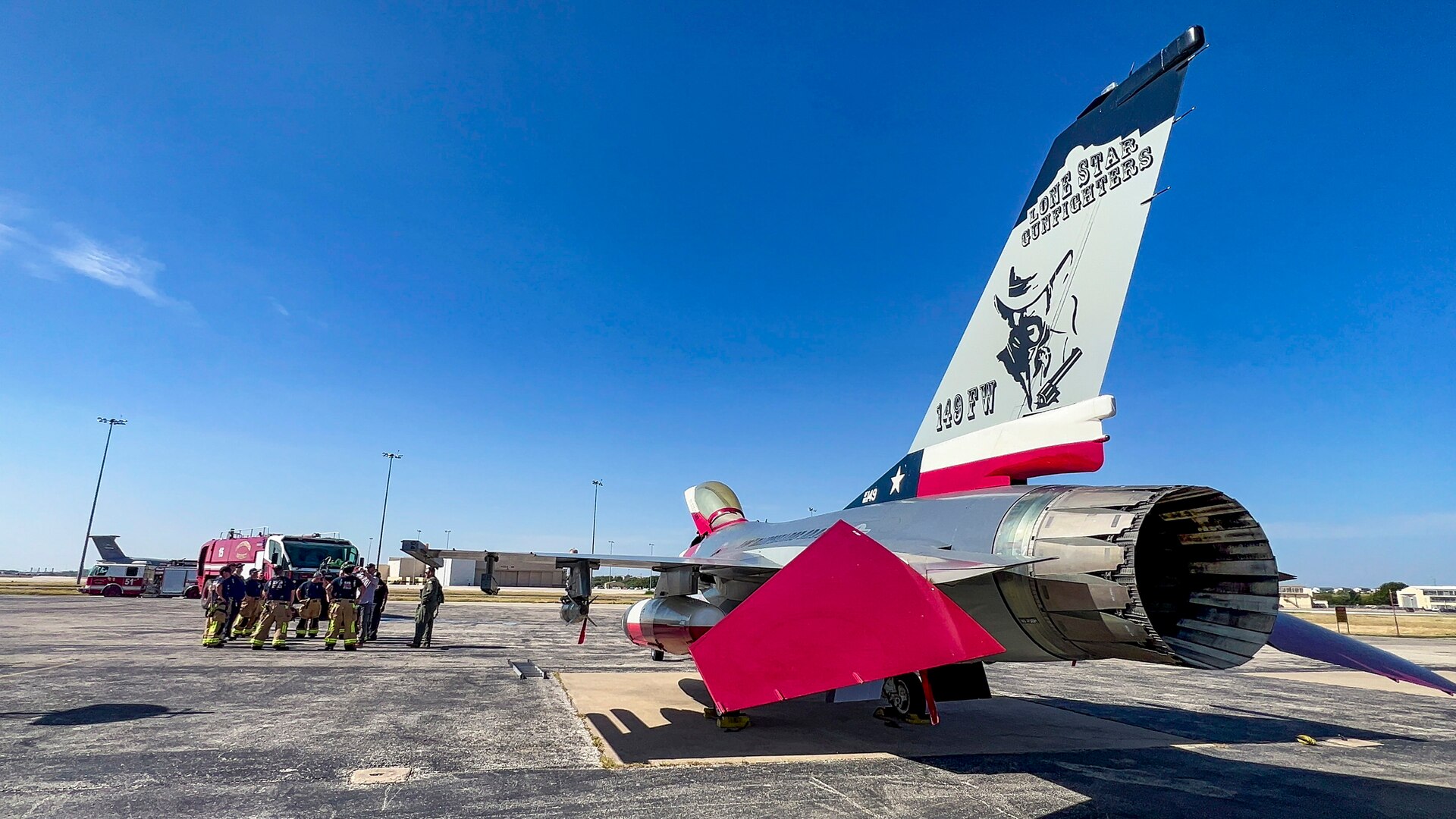 Firefighters from the 902nd Civil Engineer Squadron come together after an emergency response egress exercise for an F-16 Fighting Falcon at Joint Base San Antonio-Lackland, Texas, Aug. 19, 2022