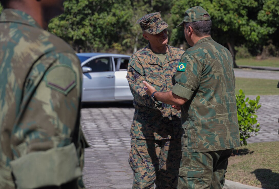 U.S. Marine Corps Brig. Gen. Len "Loni" Anderson, commanding general of 4th Marine Aircraft Wing, Marine Forces Reserve, and Contra-Almirante Marcelo Guimaràres Dias (Rear Admiral Brazilian Marine Corps), shake hands during a visit as part of exercise UNITAS LXIII in Ilha do Governador, Rio de Janeiro, Sept. 6, 2022. UNITAS is the world’s longest-running annual multinational maritime exercise that focuses on enhancing interoperability among multiple nations and joint forces during littoral and amphibious operations in order to build on existing regional partnerships and create new enduring relationships that promote peace, stability and prosperity in the U.S. Southern Command’s area of responsibility. (U.S. Marine Corps photo by Lance Cpl. Trystan Taft)
