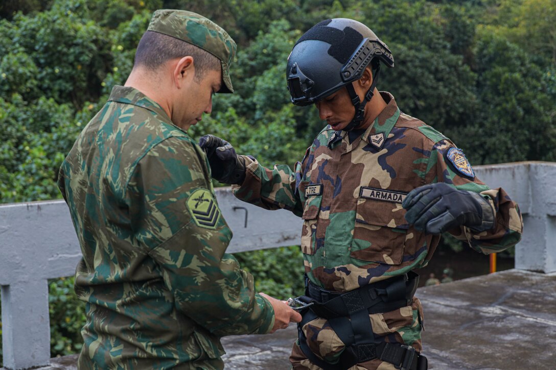 A Brazilian Marine adjusts the harness of a Dominican Republic Marine during a rappel tower training event as part of exercise UNITAS LXIII in Ilha do Governador, Rio de Janeiro, Sept. 5, 2022. UNITAS is the world’s longest-running annual multinational maritime exercise that focuses on enhancing interoperability among multiple nations and joint forces during littoral and amphibious operations in order to build on existing regional partnerships and create new enduring relationships that promote peace, stability and prosperity in the U.S. Southern Command’s area of responsibility. (U.S. Marine Corps photo by Lance Cpl. Trystan Taft)