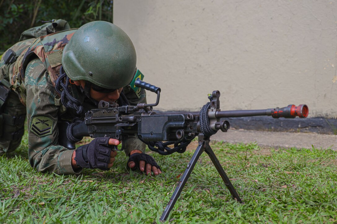A Brazilian Marine gets into a security position while conducting urban operations training during exercise UNITAS LXIII in Ilha do Governador, Rio de Janeiro, Sept. 5, 2022. UNITAS is the world’s longest-running annual multinational maritime exercise that focuses on enhancing interoperability among multiple nations and joint forces during littoral and amphibious operations in order to build on existing regional partnerships and create new enduring relationships that promote peace, stability and prosperity in the U.S. Southern Command’s area of responsibility. (U.S. Marine Corps photo by Lance Cpl. Trystan Taft)