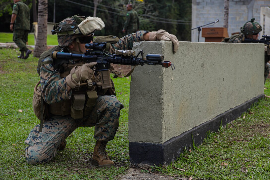 A U.S. Marine posts security while conducting urban operations training during exercise UNITAS LXIII in Ilha do Governador, Rio de Janeiro, Sept. 5, 2022. UNITAS is the world’s longest-running annual multinational maritime exercise that focuses on enhancing interoperability among multiple nations and joint forces during littoral and amphibious operations in order to build on existing regional partnerships and create new enduring relationships that promote peace, stability and prosperity in the U.S. Southern Command’s area of responsibility. (U.S. Marine Corps photo by Lance Cpl. Trystan Taft)