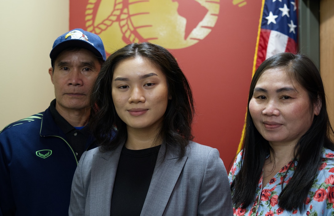 Ei Ei Naing poses for a photo with her parents Ya Naing and Ma Ye at Recruiting Sub-Station West Des Moines, Iowa, January 6, 2021. Naing is the recipient of the Naval Reserve Officer Training Corps Scholarship for Recruiting Station Des Moines Iowa/Nebraska. Born into a refugee camp, Naing and her parents immigrated to the United States for a better life and provide their daughter with better opportunities. (Marine Corps Photo by Sgt. Smithers, Timothy, R./Released)