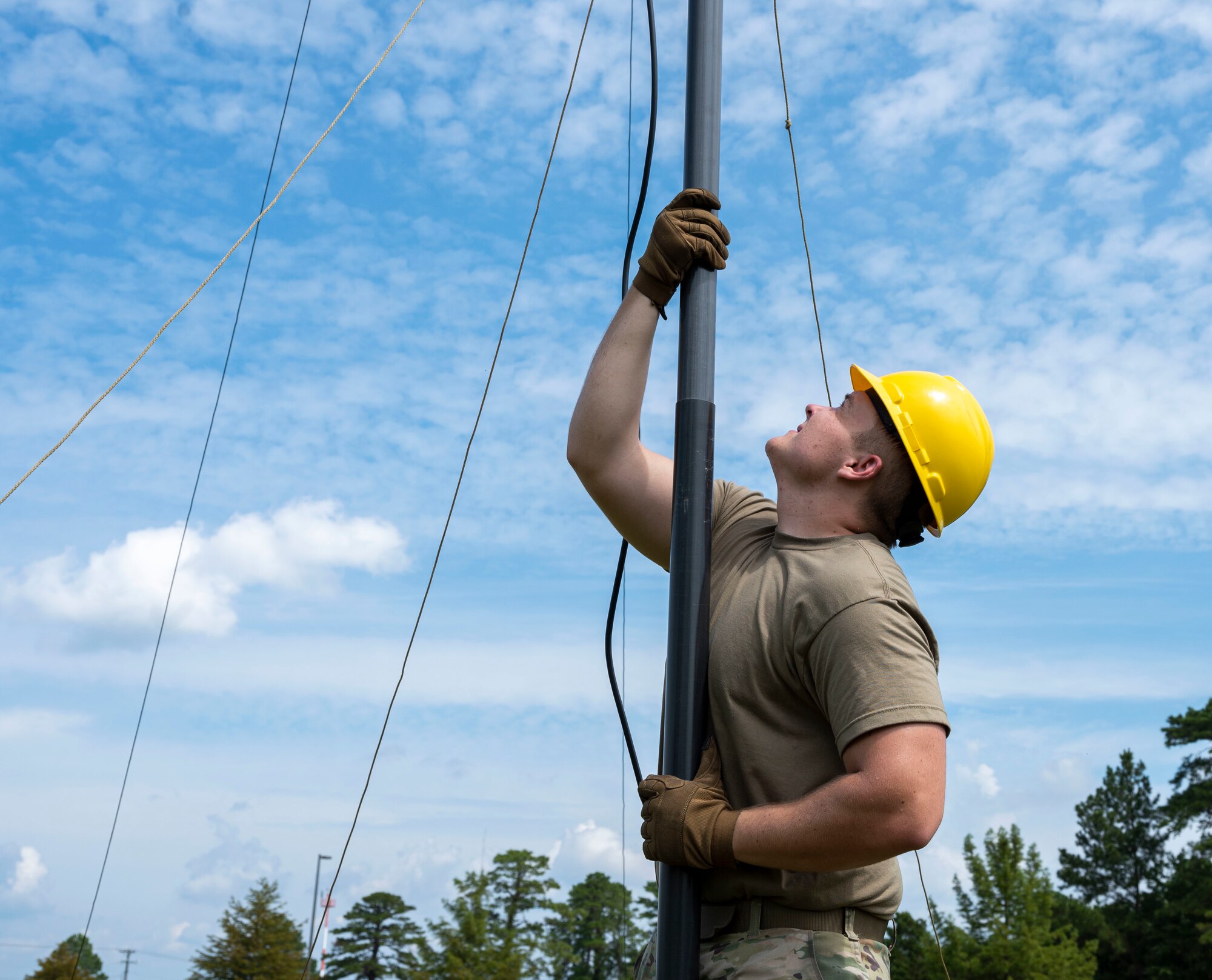 Senior Airman Brendon Rush, 4th Communications Squadron radio frequency transmission technician, assembles a tactical mass-communication antenna during Exercise Agile Cub 22 at Seymour Johnson Air Force Base, North Carolina, August 25, 2022. Rush is responsible for installing and maintaining radio frequency communications, troubleshooting and repairing communications devices; antenna systems, tuners and transmission lines. (U.S. Air Force photo by Airman 1st Class Sabrina Fuller)