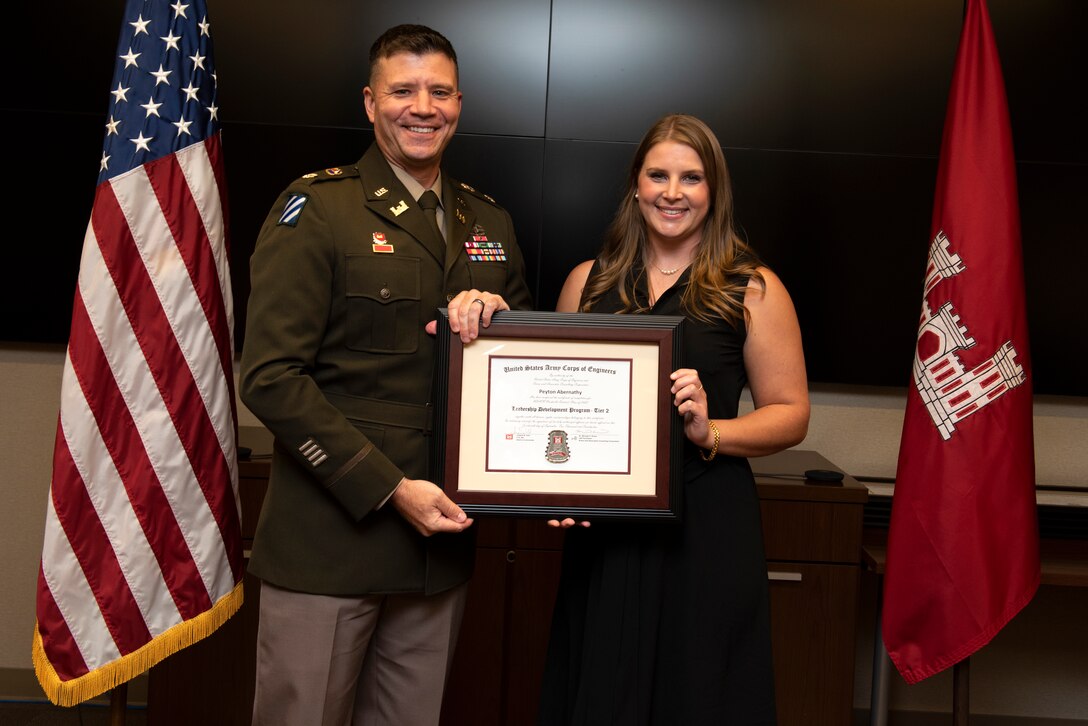 Peyton Abernathy, U.S. Army Corps of Engineers Nashville District, receives a certificate of completion for the 2022 Leadership Development Program Level II Course from Lt. Col. Joseph Sahl, Nashville District commander, and Michael Evans, course instructor, during a graduation ceremony Sept. 14, 2022, at the district headquarters in Nashville, Tennessee. (USACE Photo by Lee Roberts)