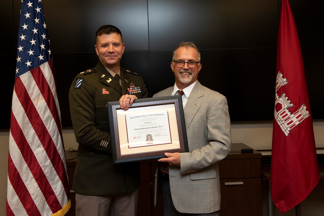 Bill Avant, U.S. Army Corps of Engineers Nashville District, receives a certificate of completion for the 2022 Leadership Development Program Level II Course from Lt. Col. Joseph Sahl, Nashville District commander, and Michael Evans, course instructor, during a graduation ceremony Sept. 14, 2022, at the district headquarters in Nashville, Tennessee. (USACE Photo by Lee Roberts)