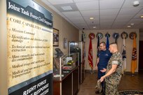 U.S. Marine Corps Lt. Col. Christopher Grasso, Joint Task Force Civil Support Operations Officer, details the history of the command and headquarters building to North American Aerospace Defense Command and U.S. Northern Command Deputy Operations Officer and Exercise Director, Coast Guard Rear Adm. Sean Regan, during his visit to JTF-CS on Ft. Eustis, Virginia, Sept. 14, 2022.