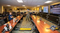 U.S. Marine Corps Lt. Col. Christopher Grasso, Joint Task Force Civil Support Operations Officer, discusses joint operation center integration with North American Aerospace Defense Command and U.S. Northern Command and the JTF-CS mission with NORAD and USNORTHCOM Deputy Operations Officer and Exercise Director, Coast Guard Rear Adm. Sean Regan, during his visit to JTF-CS headquarters on Ft. Eustis, Virginia, Sept. 14, 2022.