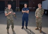 U.S. Marine Corps Lt. Col. Christopher Grasso, left, Joint Task Force Civil Support Operations Officer, and U.S. Army Maj. Darren Hamby, right, JTF-CS Incident Support Team 1 Officer-in-Charge, describe the team’s ability to rapidly deploy in response to a catastrophic manmade or natural disaster to North American Aerospace Defense Command and U.S. Northern Command Deputy Operations Officer and Exercise Director, Coast Guard Rear Adm. Sean Regan, during his visit to JTF-CS headquarters on Ft. Eustis, Virginia, Sept. 14, 2022.