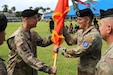 U.S. Army Brig. Gen. Jan C. Norris hand off the guidon to Gen. Charles A. Flynn, U.S. Army Pacific commander, relinquishing his command of the 311th Signal Command (Theater) at Palm Circle in Fort Shafter, Hawaii, on July 15, 2022. (U.S. Army photo by Capt. Christopher Kim) (Capt. Christopher Kim)
