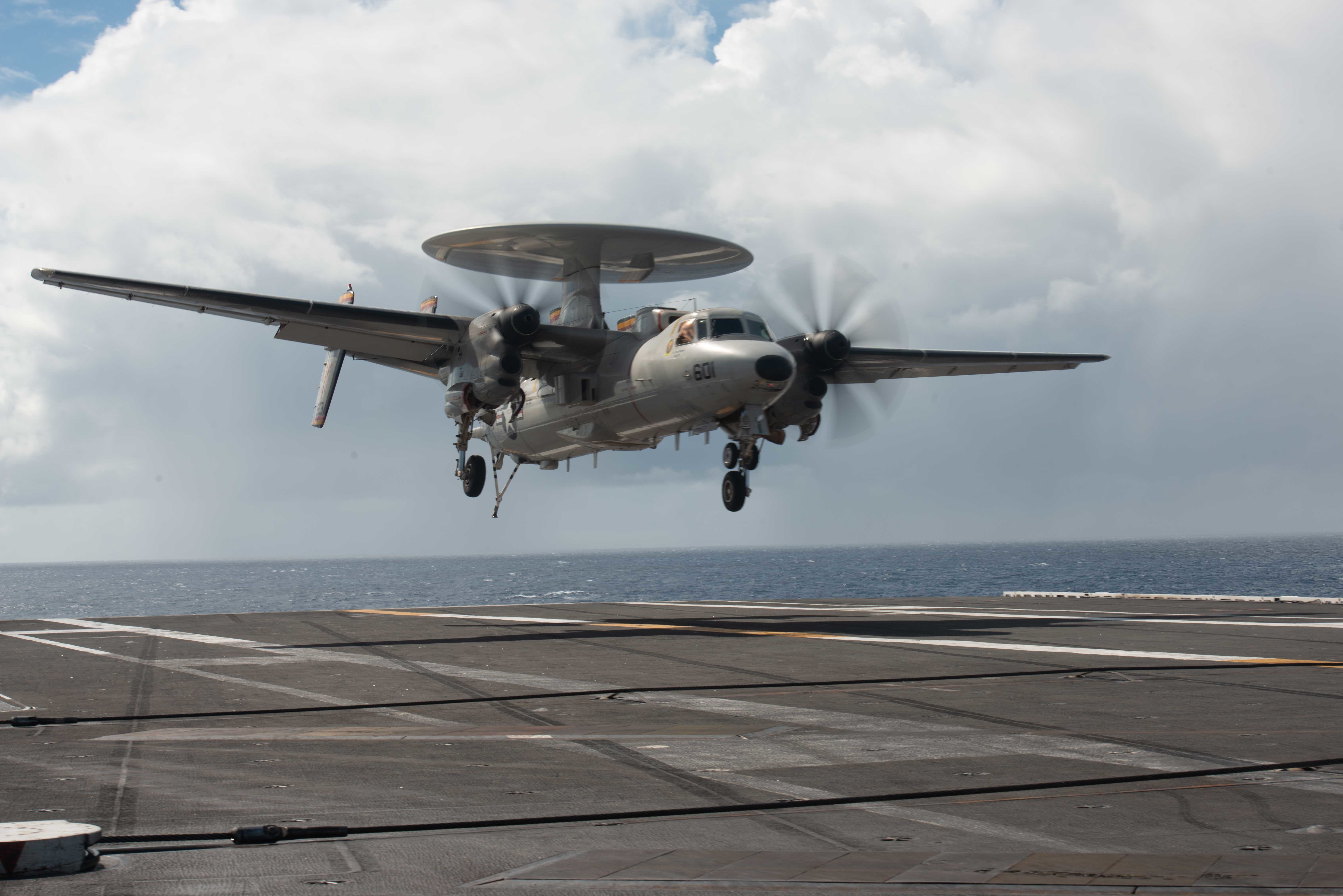 An E-2D Hawkeye lands on the flight deck of the U.S. Navy's only forward-deployed aircraft carrier, USS Ronald Reagan (CVN 76), in the Pacific Ocean.