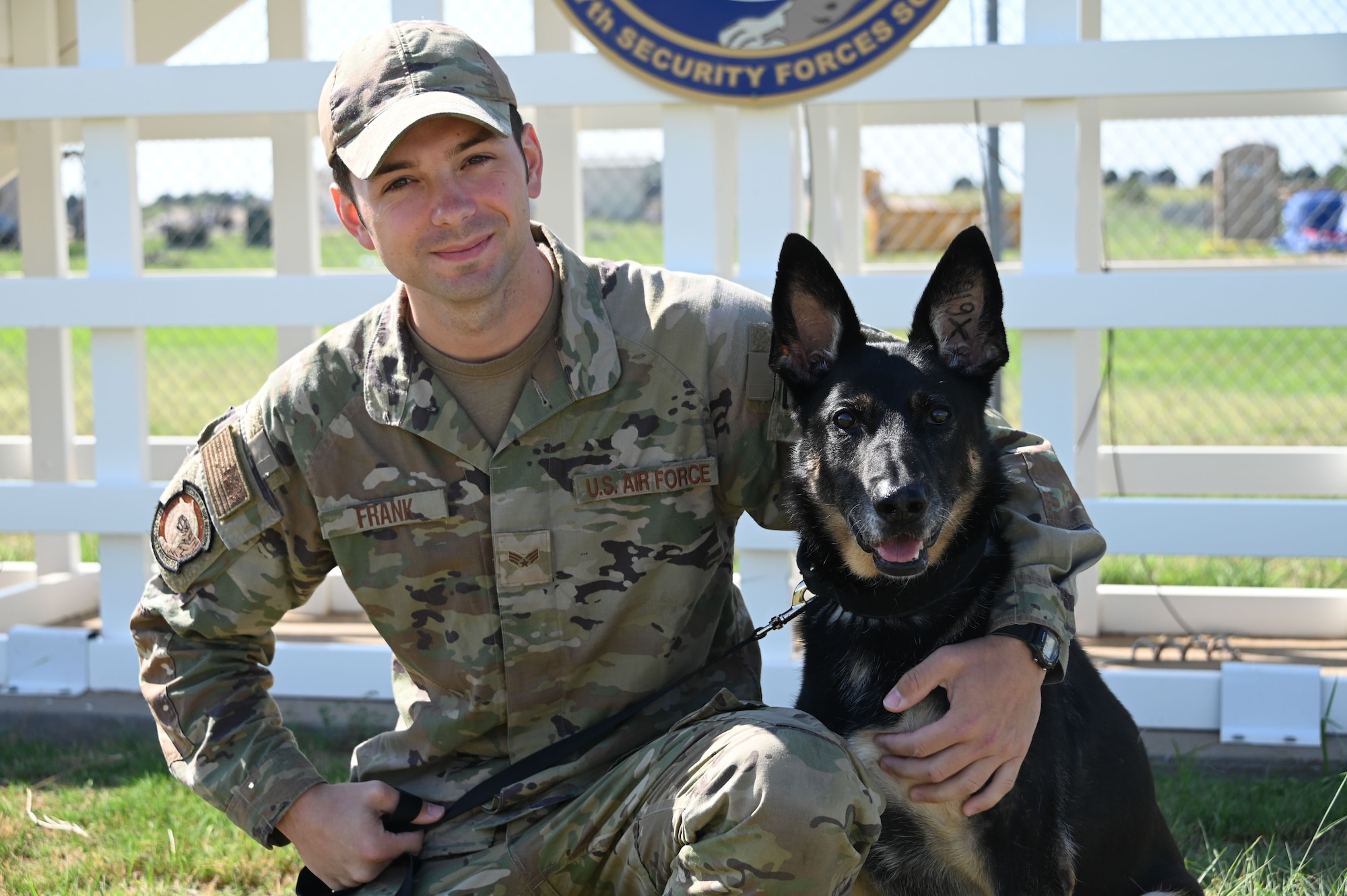 U.S. Air Force Senior Airman Trevor Frank, 97th Security Forces Squadron military working dog (MWD) handler, holds a toy in front of Cora, retired MWD, at Altus Air Force Base, Oklahoma, Sept. 9, 2022. Cora is rewarded for her training with dog toys. (U.S. Air Force photo by Senior Airman Kayla Christenson)
