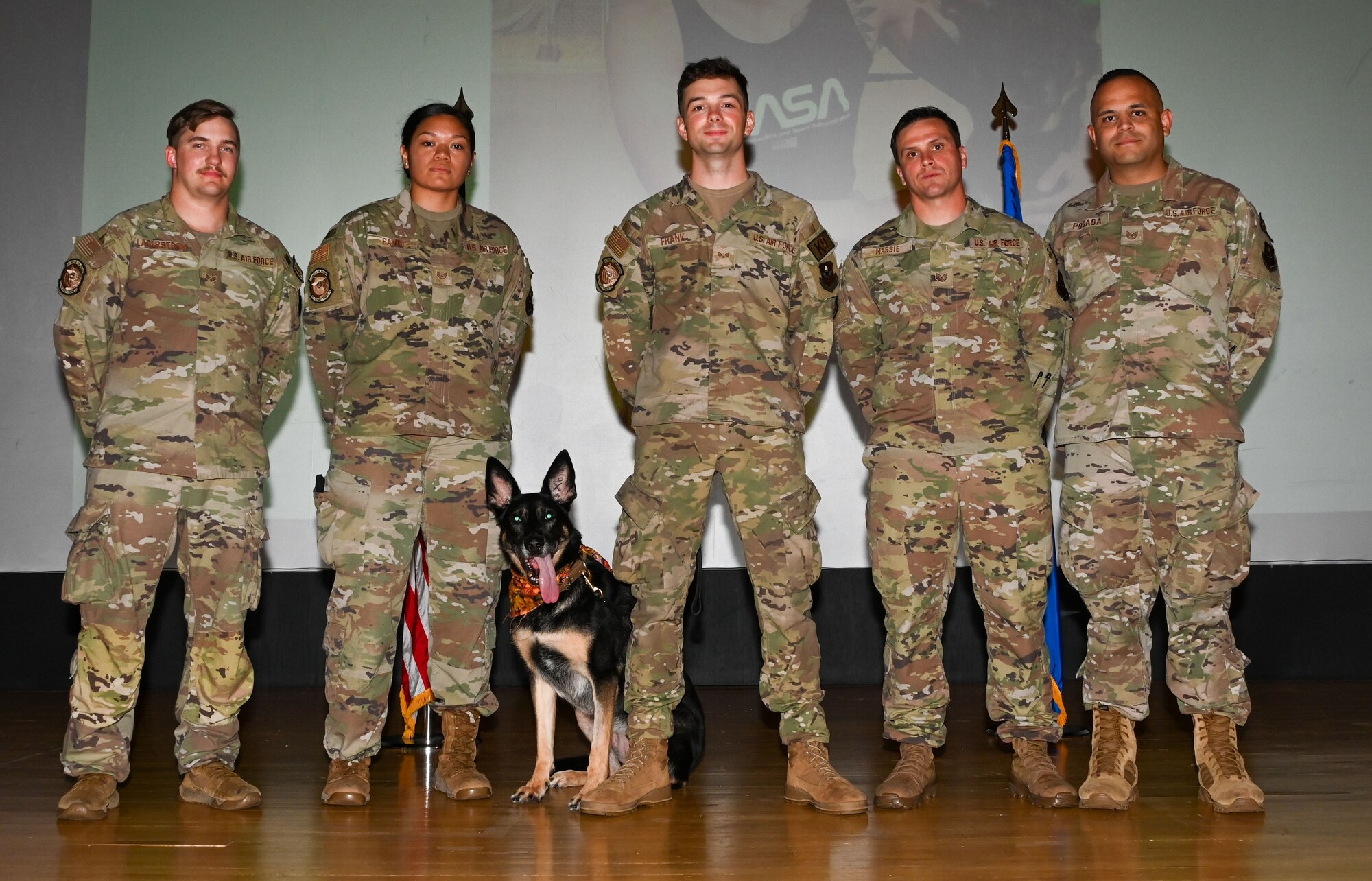 Cora, 97th Security Forces Squadron (SFS) military working dog (MWD), poses with the 97th SFS MWD team during Cora’s retirement ceremony at Altus Air Force Base (AAFB), Oklahoma, Sep. 15, 2022. Cora is the first MWD to retire from AAFB in three years. (U.S. Air Force photo by Senior Airman Kayla Christenson)