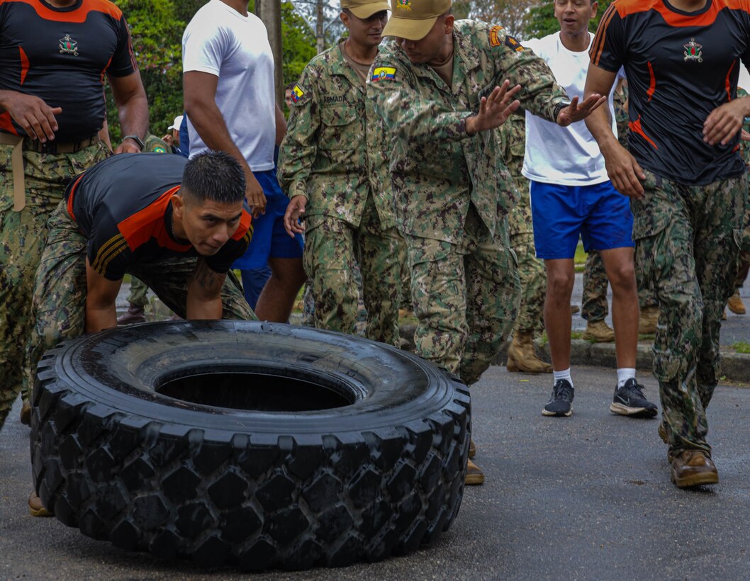 A Ecuadorian Marine flips a tire during one of the physical fitness stations held in a 'Marine of Steel' event in Ilha do Governador, Rio de Janeiro, during a sports event, during exercise UNITAS LXIII, Sept. 4, 2022. UNITAS is the world’s longest-running annual multinational maritime exercise that focuses on enhancing interoperability among multiple nations and joint forces during littoral and amphibious operations in order to build on existing regional partnerships and create new enduring relationships that promote peace, stability and prosperity in the U.S. Southern Command’s area of responsibility. (U.S. Marine Corps photo by Lance Cpl. Trystan Taft)