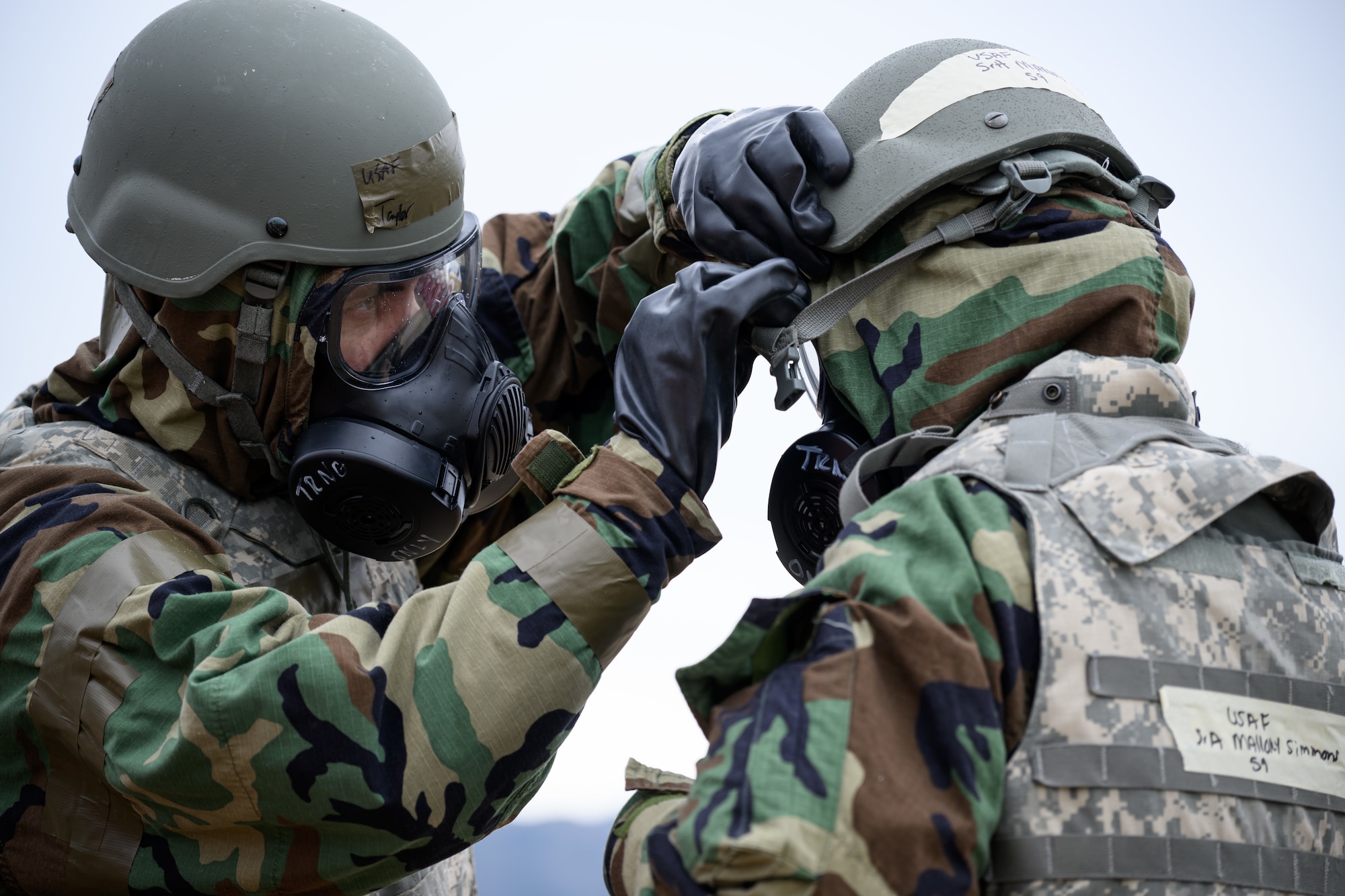 Left, Airman 1st Class Matthew Taylor, 75th Logistics Readiness Squadron, assists Airman 1st Class Mallory Simmons, 75th Air Base Wing, don protective gear during an Ability to Survive and Operate rodeo (ATSO) at Hill Air Force Base, Utah, Sept. 13, 2022.