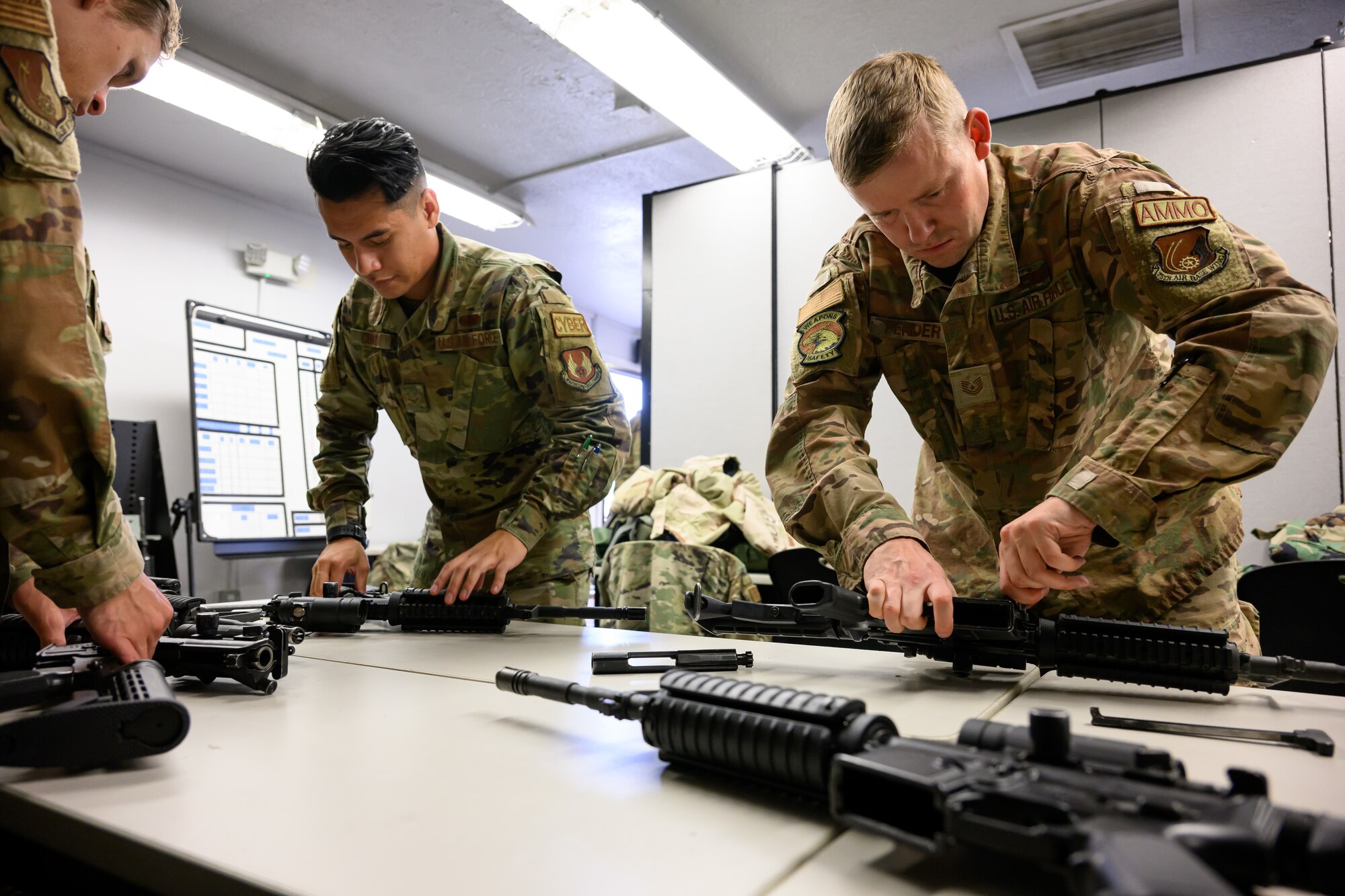 Right, Tech. Sgt. Kraig Fender and Airman 1st Class Addison Cuadra, 75th Air Base Wing, tear down weapons during an Ability to Survive and Operate rodeo (ATSO) at Hill Air Force Base, Utah, Sept. 13, 2022.