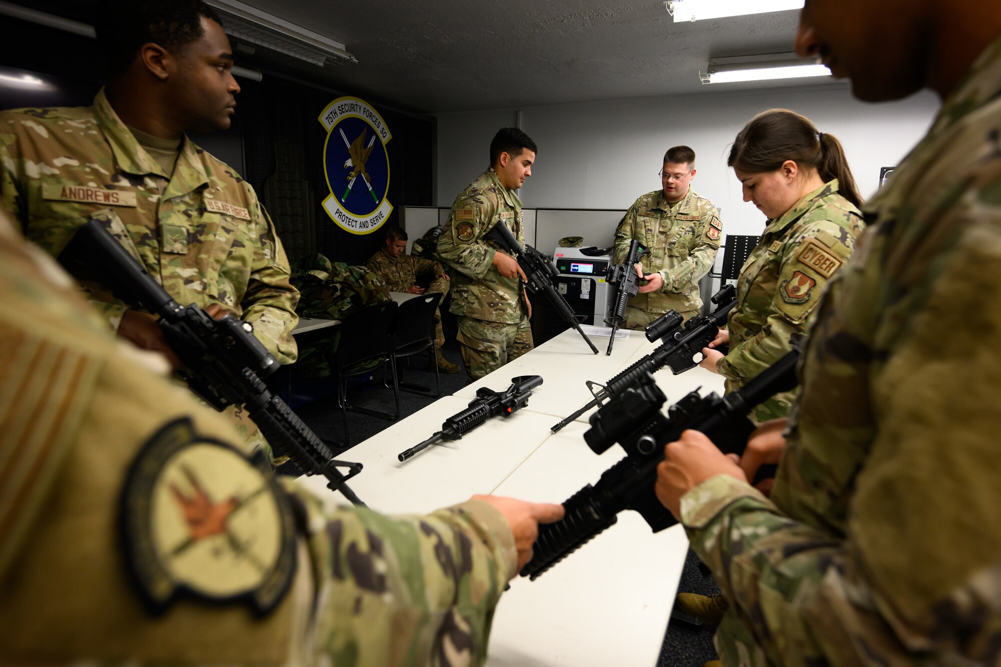 Center, Tech. Sgt. Ronald Smith, 75th Security Forces Squadron, instructs Airmen on weapons handling during an Ability to Survive and Operate rodeo (ATSO) at Hill Air Force Base, Utah, Sept. 13, 2022.