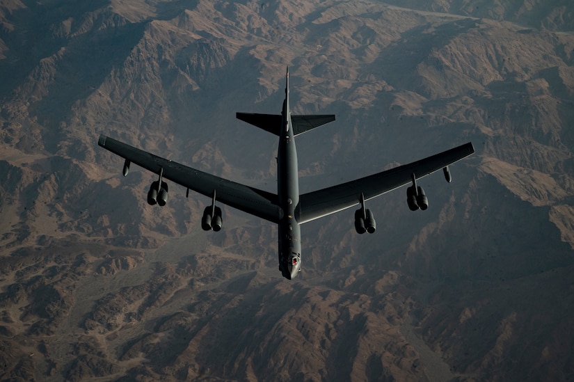 A bomber flies though the air.