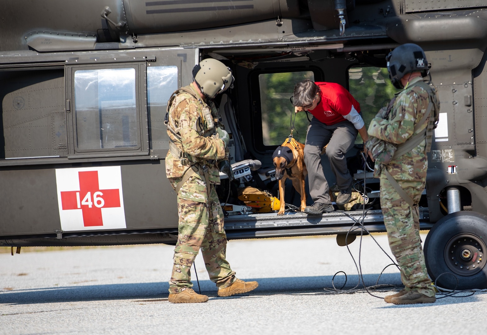 Nikki Gamman and K-9 Gunner of New England K-9 Search and Rescue conduct noise acclimation with a NHARNG aviation crew during annual search and rescue training held by Fish and Game at Cannon Mountain in Franconia on Sept. 10, 2022.