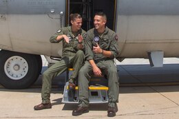 U.S. Marine Corps Lt. Col. Courtney “Britney” O’Brien, left, commanding officer of Marine Aerial Refueler Transport Squadron 352, Marine Aircraft Group (MAG) 11, 3rd Marine Aircraft Wing (MAW) and Lt. Col. Michael “Snooki” O’Brien, right, commanding officer of Marine Fighter Attack Squadron 314, MAG 11, 3rd MAW, laugh together on a KC-130J Super Hercules on Marine Corps Air Station Miramar, California, Sept. 13, 2022. The two married Marines took command of their squadrons on the same day. (U.S. Marine Corps photo by Lance Cpl. Courtney A. Robertson)