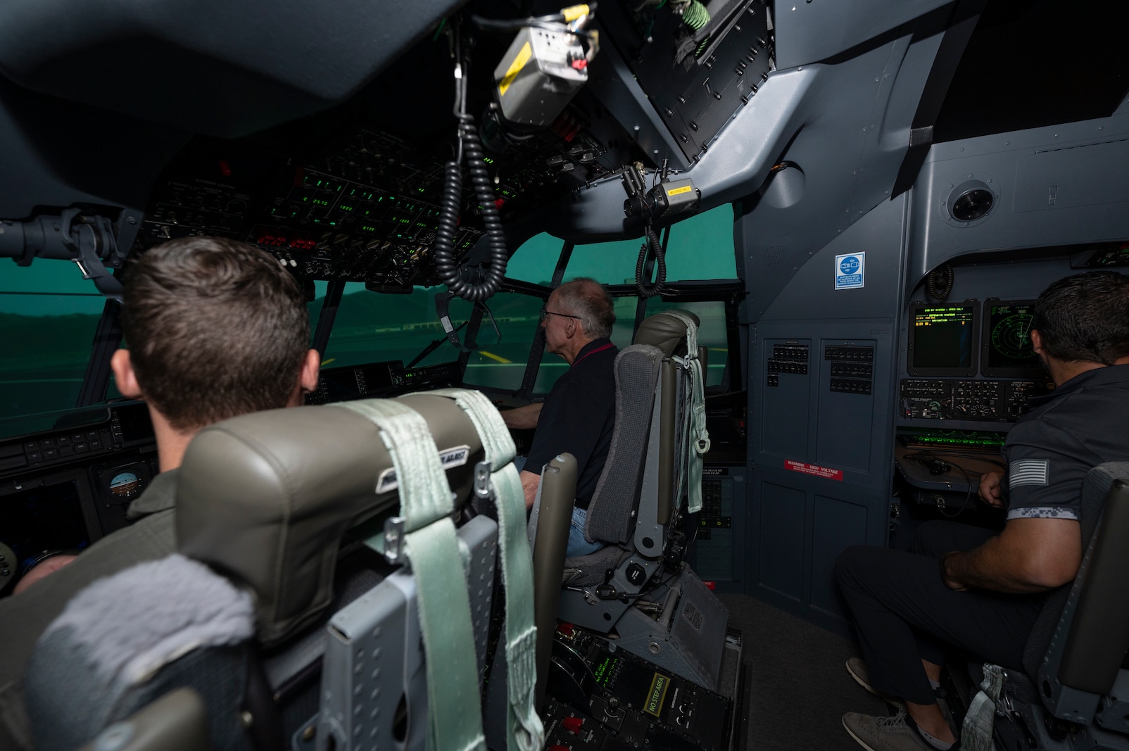 a picture of people inside a simulated airplane
