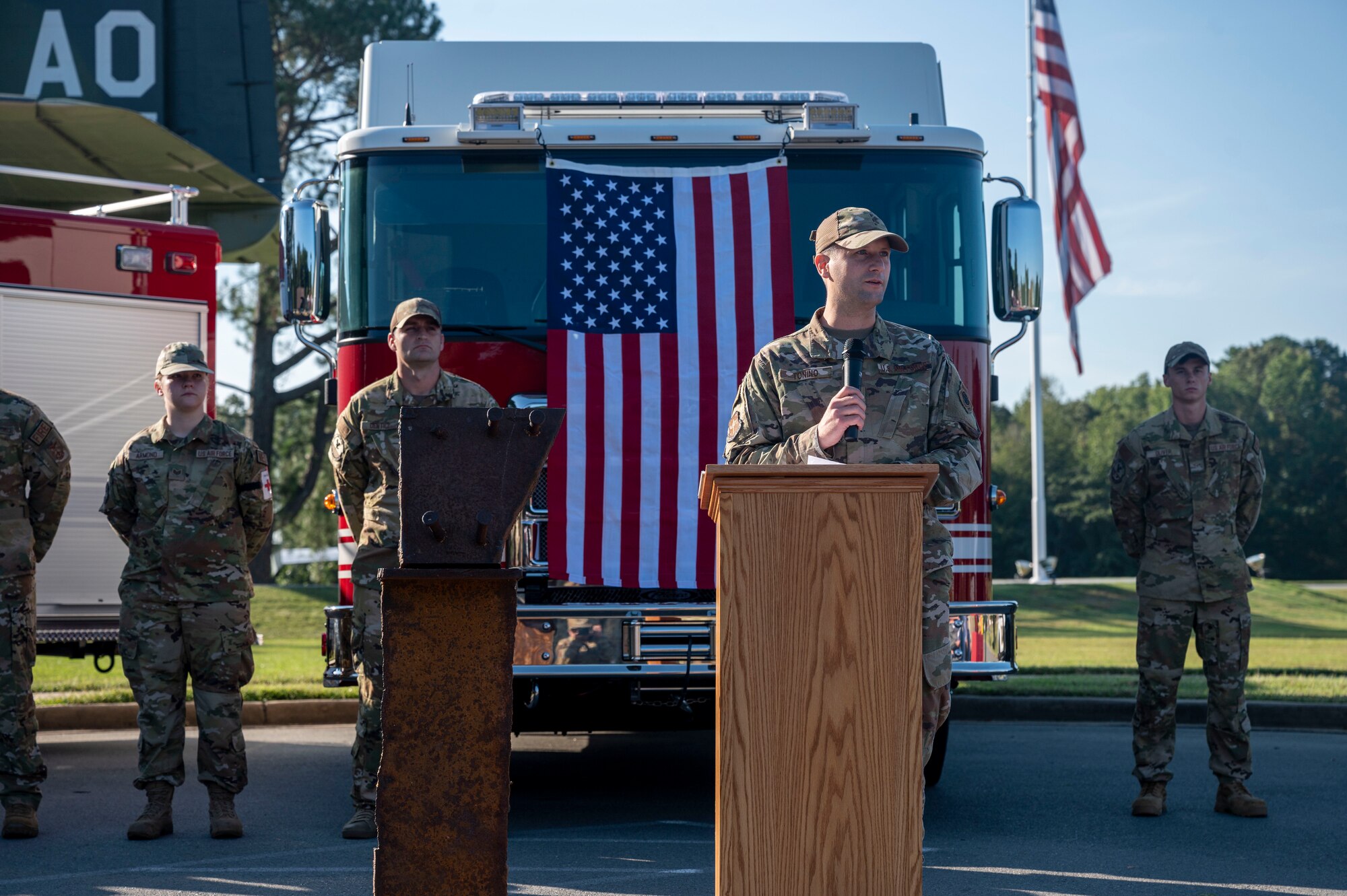 A man in uniform gives remarks at a ceremony