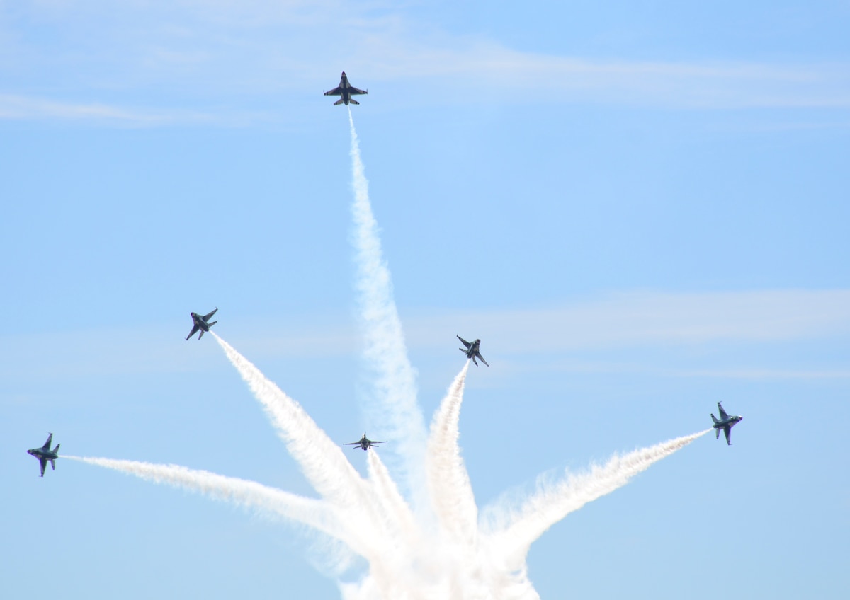The United States Air Force Thunderbirds Aerial Demonstration Team race across the horizon in their F-16 Fighting Falcons at Maxwell Air Force Base, Alabama during the Heritage to Horizon Airshow on April 8, 2017.