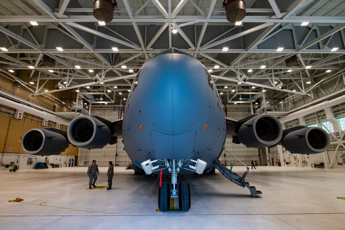 Airmen assigned to the 911th Maintenance Group finalize the towing process of the first C-17 Globemaster III to enter the new two-bay hangar at the Pittsburgh International Airport Air Reserve Station, Pennsylvania