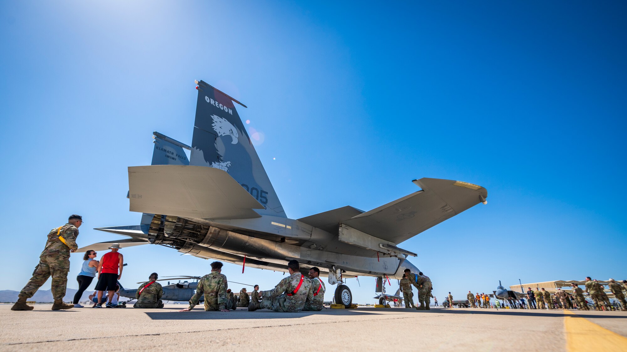 U.S. Air Force Airmen, Luke Air Force Base supporters, and civic leaders from surrounding communities gather under the shade of an F-15C Eagle assigned to the 173rd Fighter Wing, Kingsley Field, Oregon, during the Luke AFB Supporter Appreciation Day event, May 13, 2022, at Luke AFB, Arizona.