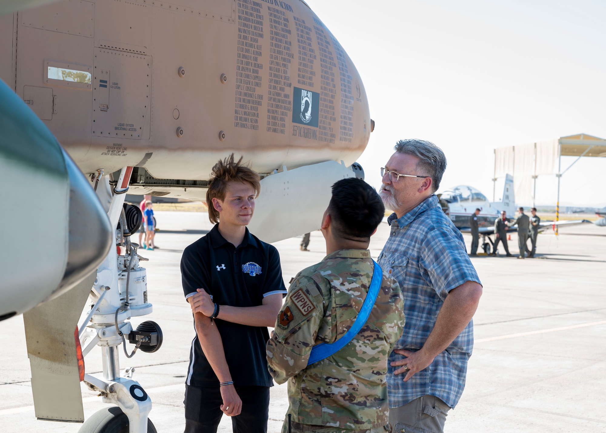 A U.S. Air Force Airman assigned to the 56th Fighter Wing speaks with Luke Air Force Base Supporter Appreciation event attendees in front of an A-10C Thunderbolt II assigned to the 355th Fighter Wing, Davis-Monthan Air Force Base, Arizona, during Luke AFB’s Supporter Appreciation event, May 13, 2022, at Luke AFB, Arizona.