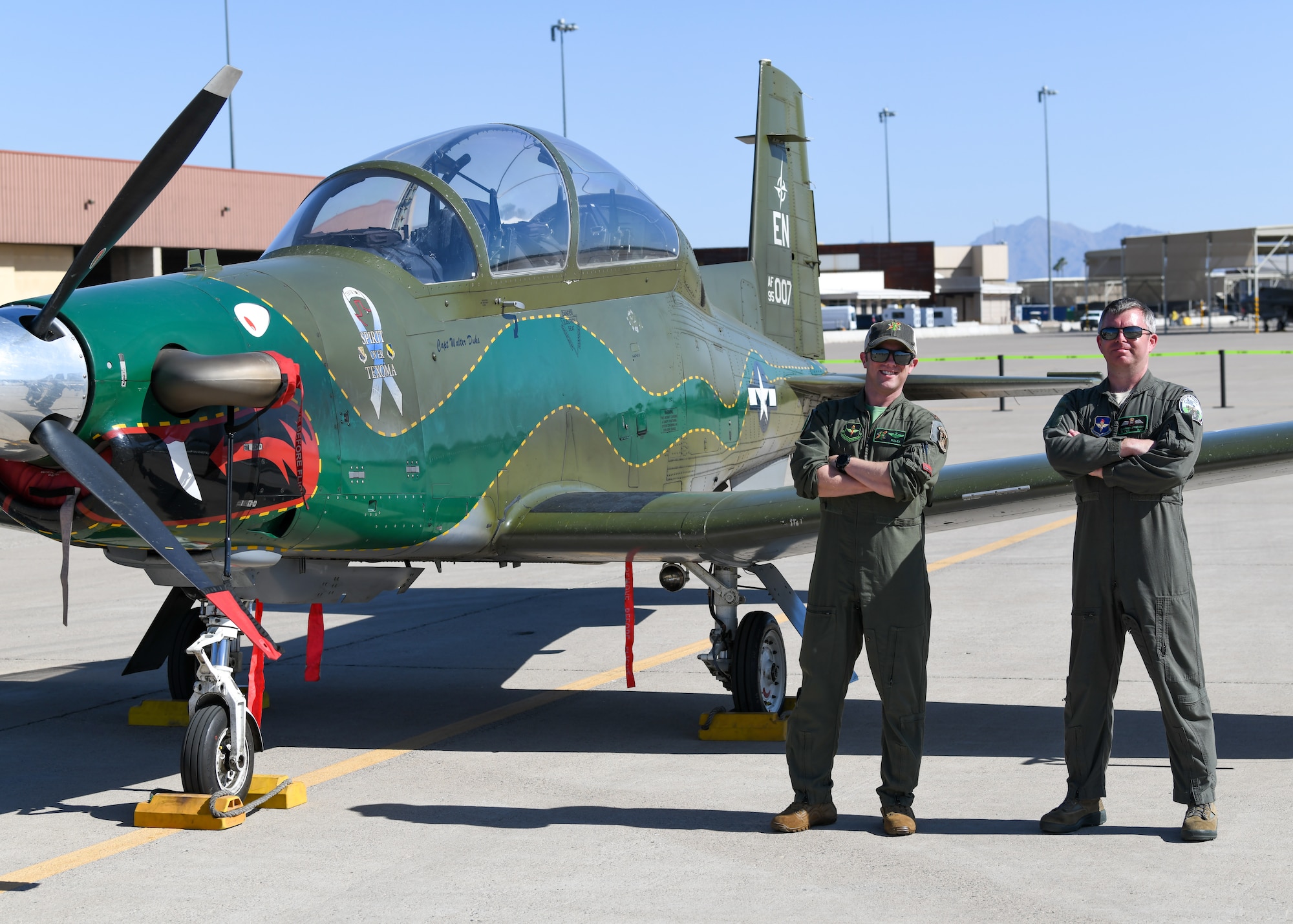 U.S. Air Force pilots assigned to the 459th Flying Training Squadron, Sheppard Air Force Base, Texas, pose in front of a T-6A Texan II aircraft during Luke Air Force Base’s Supporter Appreciation Day event, May 13, 2022, at Luke AFB, Arizona.