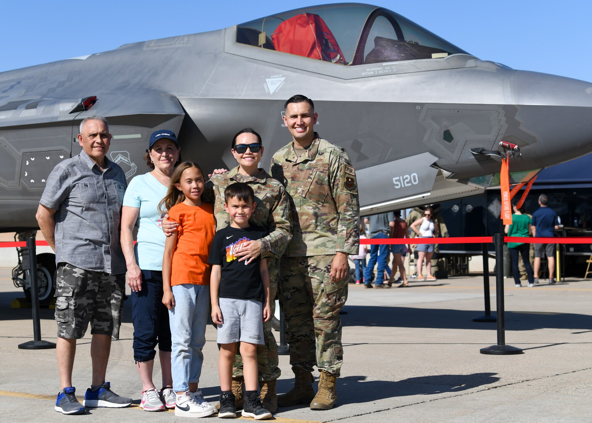 Airmen assigned to the 56th Fighter Wing pose with family in front of an F-35A Lightning II fighter jet during Luke Air Force Base’s Supporter Appreciation Day event, May 13, 2022, at Luke AFB, Arizona.