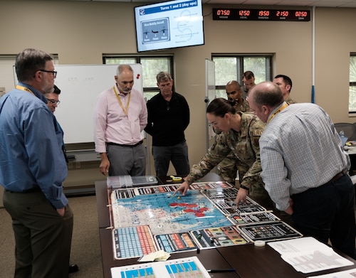 photo of a group of US military standing around a table looking at map