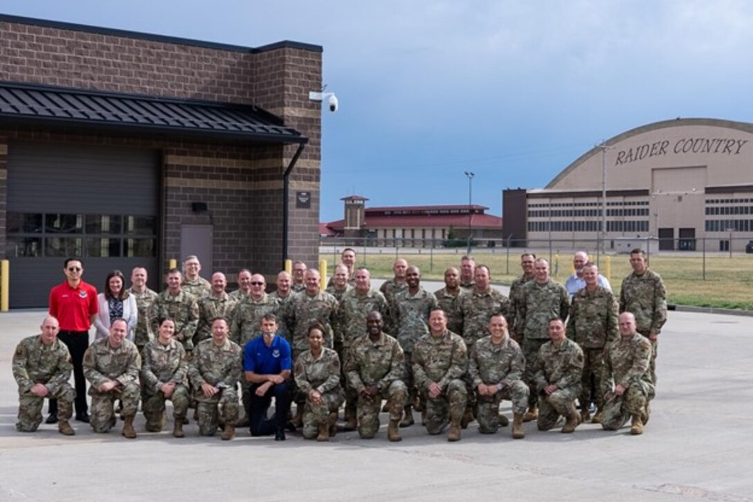 Attendees of the 2022 Air Force Global Strike Command (AFGSC) Maintenance Group Commander and Senior Enlisted Leader (SEL) Summit gather for a group photo on Ellsworth AFB, S.D., Aug. 24, 2022. The summit created discussion between maintenance commanders and SELs that promoted modernization and preparing for the future. (U.S. Air Force photo by Senior Airman Austin McIntosh)